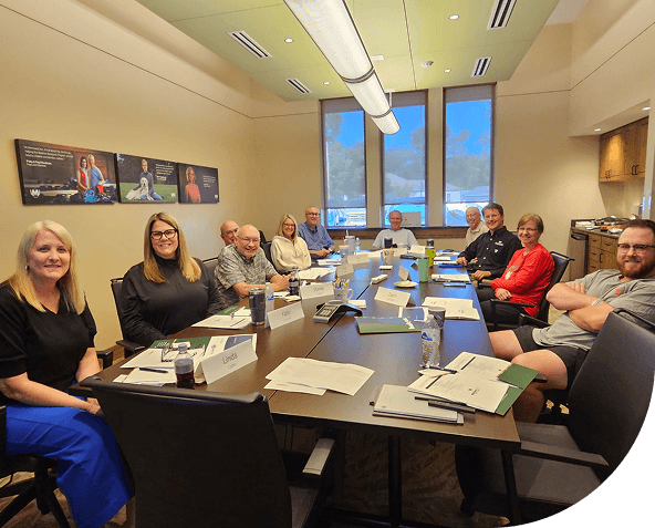 Group of people sitting around large conference table