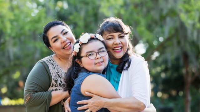 Hispanic female family members embracing